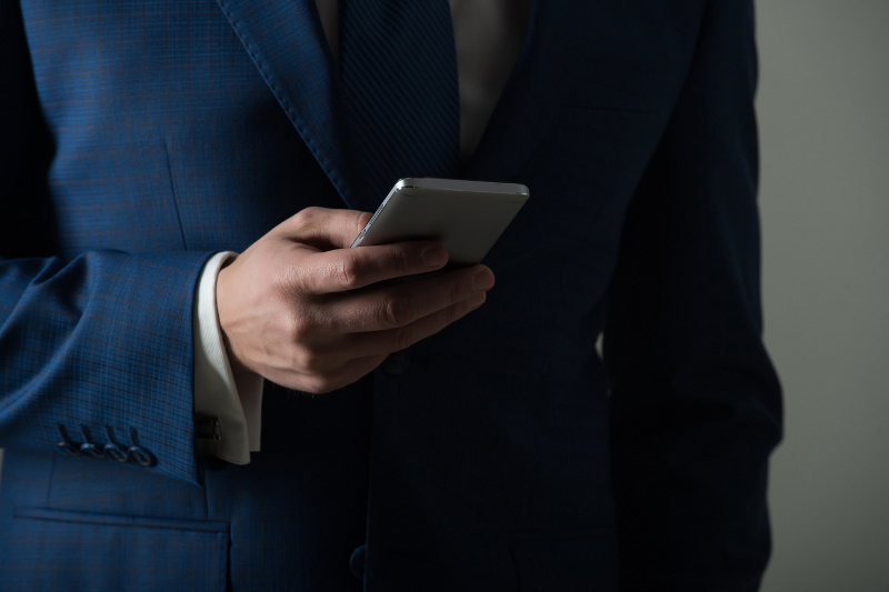 Close Up of Business Man Holding a Cell Phone