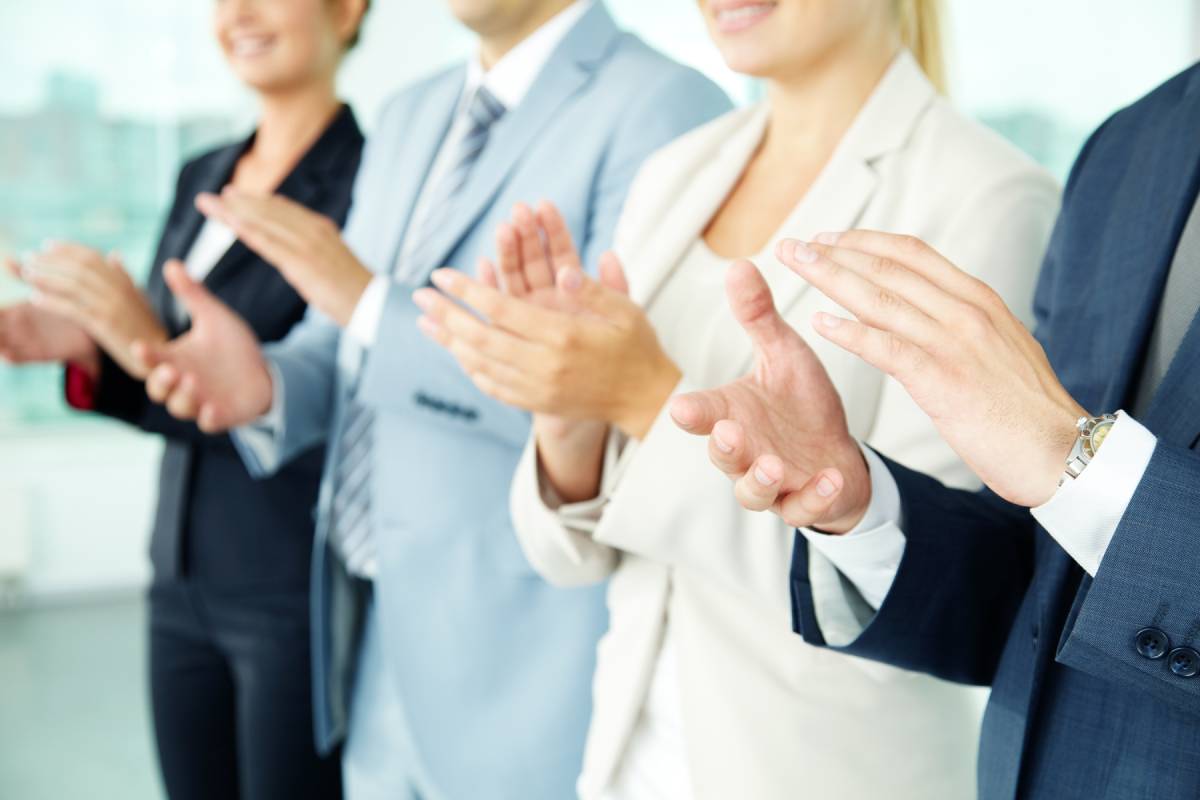 Two Businessmen and two businesswomen clapping